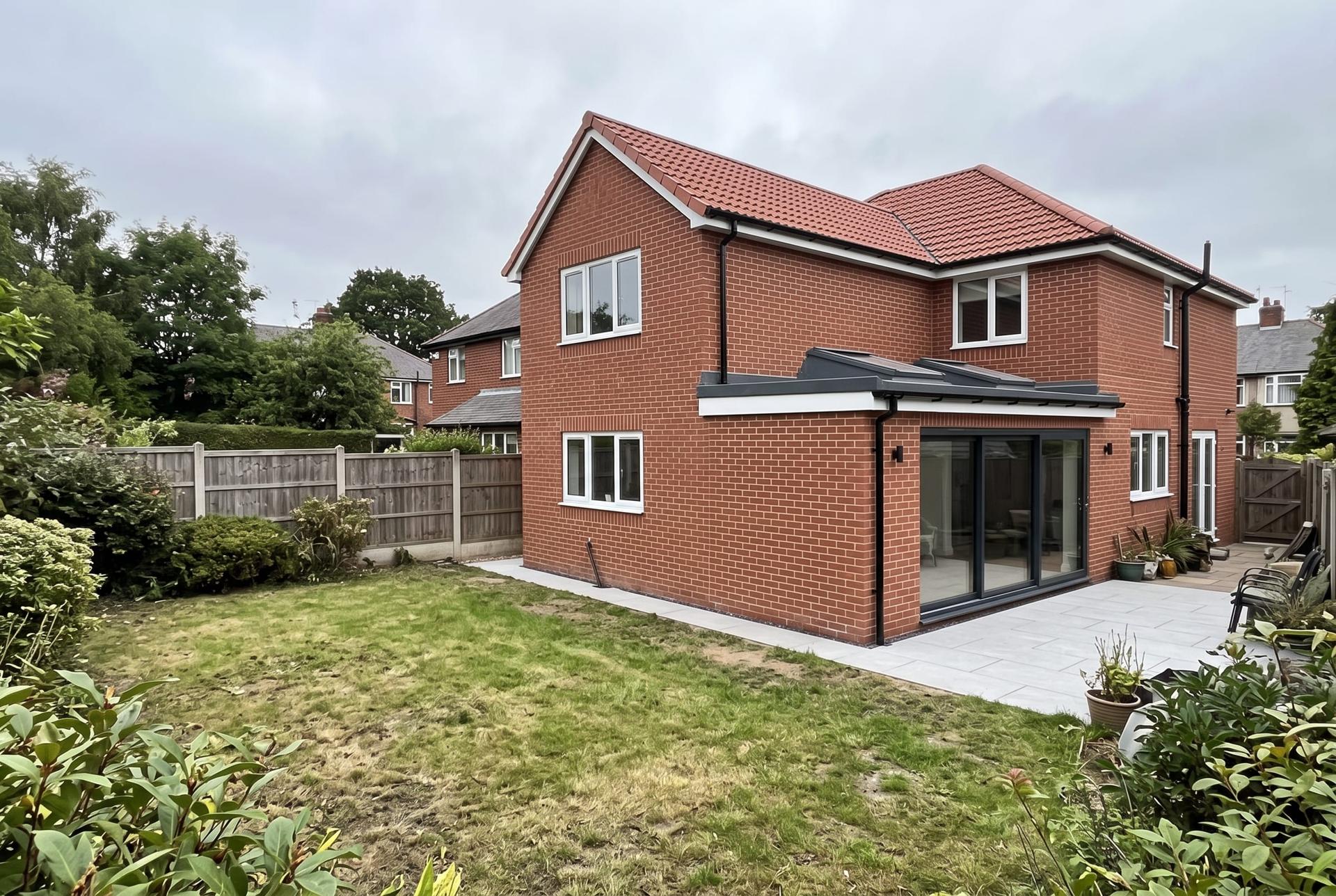 Two storey rear extension with a single storey wrap around on a brick detached house
